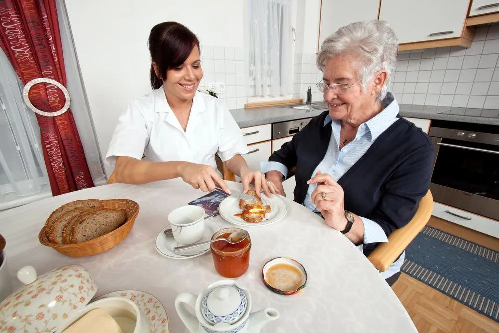 Caregiver assisting an elderly woman with personal hygiene at home