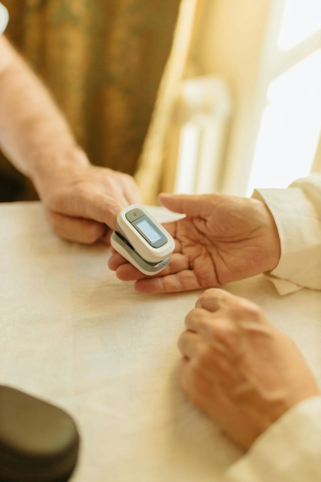 Caregiver helping a senior monitor their health at home